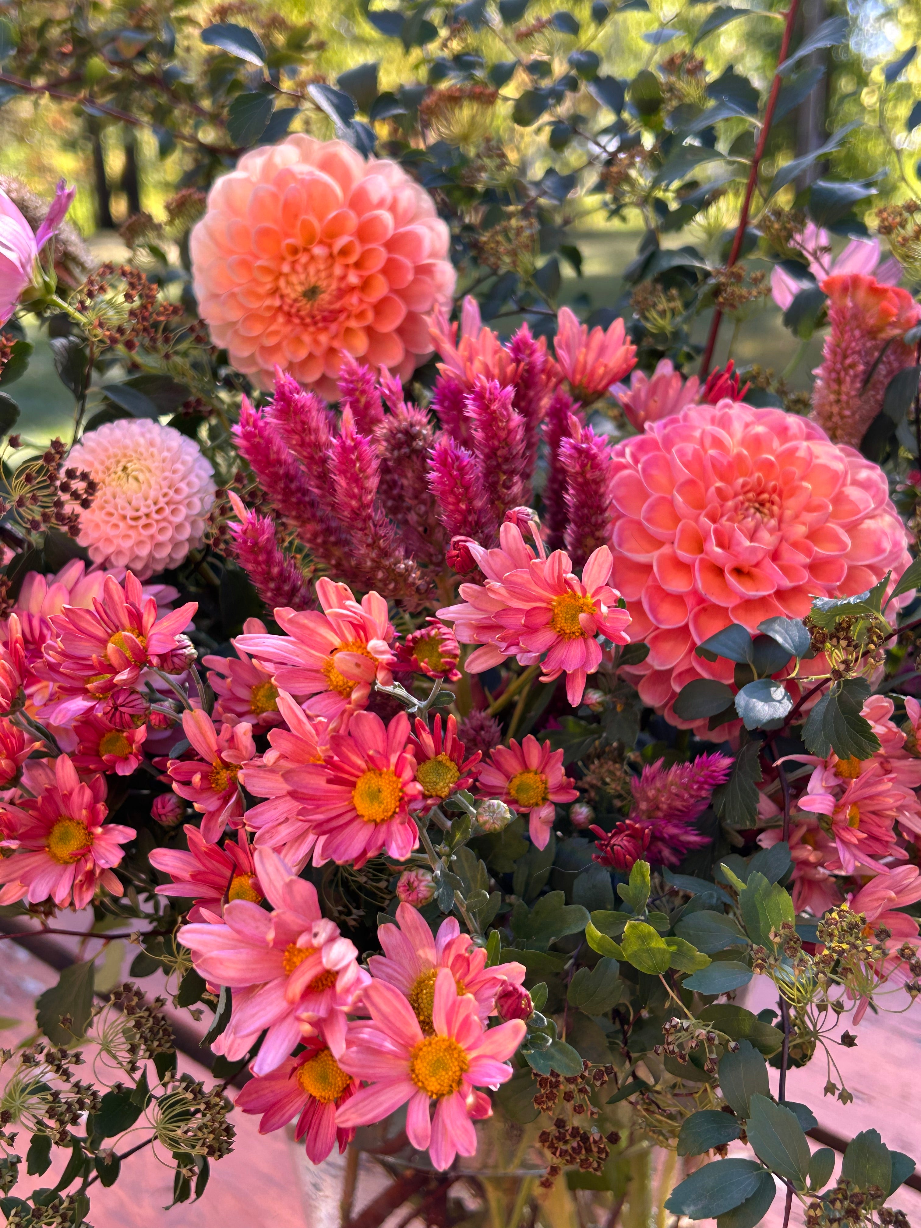 Bouquet of pink and purple flowers with green leaves