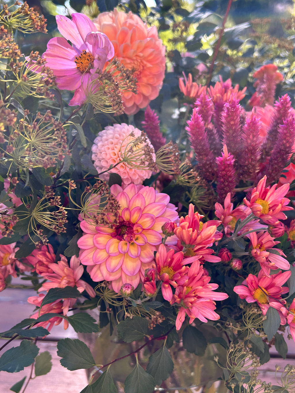 Bouquet of pink and purple flowers with green leaves