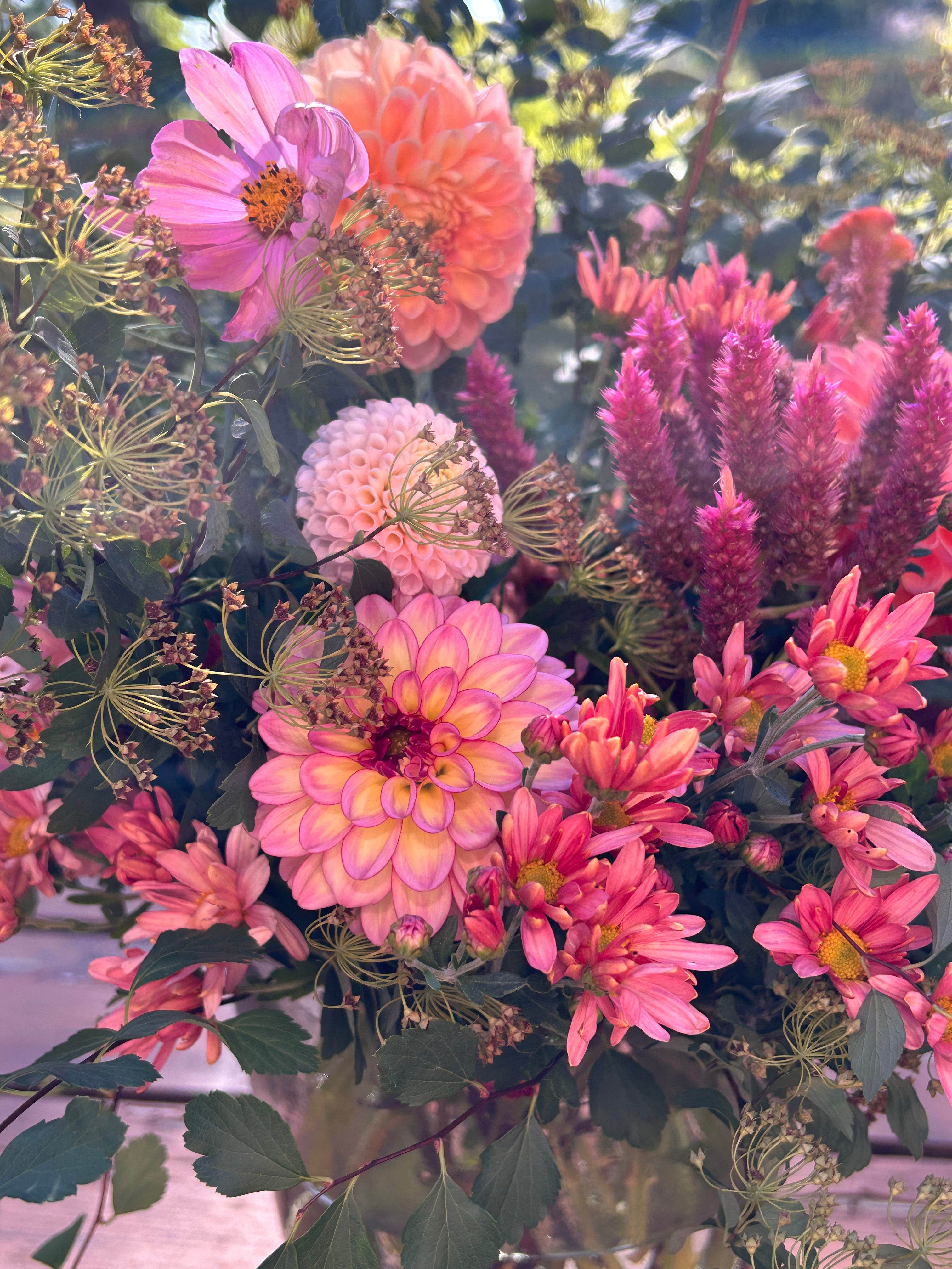 Bouquet of pink and purple flowers with green leaves